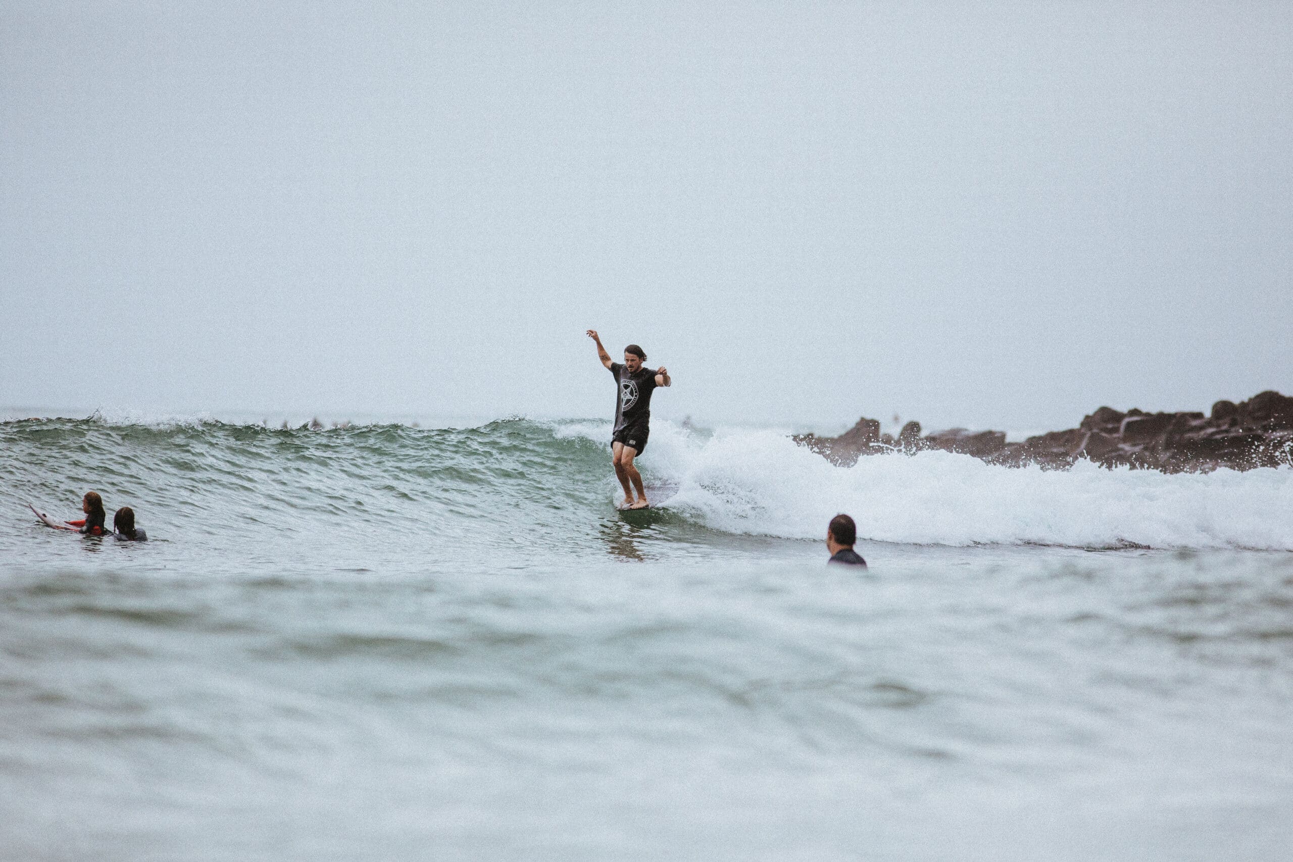 Shapers-Club- A man surfing in the ocean. -surfshop-surfboard