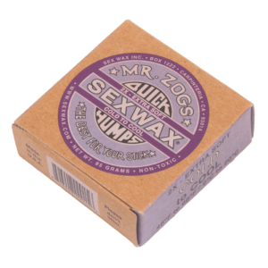 Shapers-Club- A square cardboard box containing "Sexwax - Cold" in an extra mild low-temperature formula. The beige box features purple and black labels with clear text and branding. This non-toxic product weighs 85 grams. -surfshop-surfboard