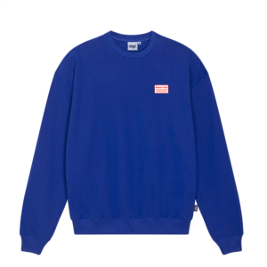 Shapers-Club- Royal blue long-sleeved crew-neck sweatshirt. It features a small red and white rectangular label on the upper left chest with the text "THE ADDRESS". The sweatshirt has a relaxed fit and ribbed cuffs and hem. -surfshop-surfboard