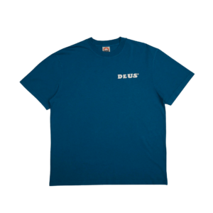 Shapers-Club- A DEUS - Real Good blue short-sleeved T-shirt, with the word "DEUS" printed in white on the left chest. The T-shirt lies flat on a white background, highlighting its simple, classic design. -surfshop-surfboard